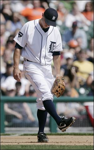 Detroit Tigers third baseman Brandon Inge kicks the dirt after throwing wide of second base for an error that allowed Kansas City Royals' Jeff Francoeur to score in the fifth inning.