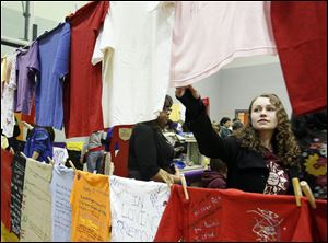 University of Toledo student Hillary Gyuras of Tiffin
looks over the Clothesline Project display at the
Take Back the Night rally Saturday in Oregon.