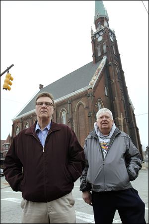 Rick Napierala, left, and Tom Robakowski, outside the former St. Anthony Catholic Church, say they have floated around since the parish's closure.