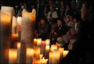 Participants offer a silent of prayer during a charity concert to raise fund for the victims of the earthquake and tsunami in Tokyo.