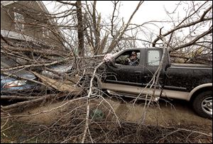 Jerry Tierney sits in his pickup as he charges his cell phone as Mapleton, Iowa, residents begin clean-up efforts Sunday after a tornado devastated part of the town Saturday evening. 