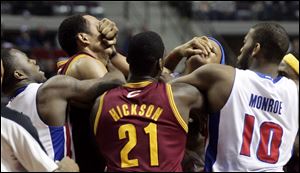 Cleveland Cavaliers' Ryan Hollins, second from left, and Detroit Pistons' Charlie Villanueva scuffle as, from left, Pistons' Rodney Stuckey, Cavaliers' J.J. Hickson (21) and Pistons' Greg Monroe (10) try to separate them in the fourth quarter of an NBA basketball game Monday in Auburn Hills, Mich.