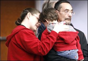 Holly Burgete and her husband, Gabriel, comfort their son, Louis, 3, during a rally at the Lucas County Courthouse in recognition of National Crime Victims’ Rights Week. Mr. Burgete’s son, General Hurst, was murdered Dec. 31, 2006, in Toledo. ‘He never got the chance to meet his brother [Louis],’ Mrs. Burgete said. The rally Monday was planned to inspire victims of all crimes, from homicide and rape to domestic abuse. President Reagan instituted National Victims’ Rights Week in 1981 as an annual observance to bring the victim-assistance community together to raise public awareness of their rights and the services available to them.