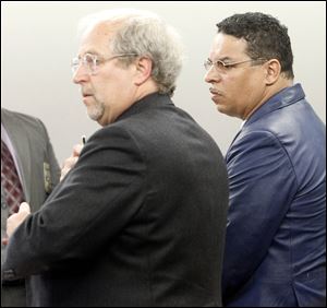 Steven Snow, right, appears in Lucas County Common Pleas Court with his lawyer, Scott Schwab. Mr. Snow is charged with reckless homicide in the deaths of four tenants by carbon monoxide poisoning. After being fingerprinted and photographed, Mr. Snow was to be freed on a supervised bond. 
