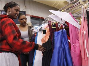 Woodward seniors Cierra Roy, left, and Donyell Sullivan shop during the Raising Awareness Club's Prom Dress Extravaganza at the Owens Community Colleges.