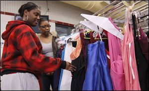Woodward seniors Cierra Roy, left, and Donyell Sullivan shop during the Raising Awareness Club's Prom Dress Extravaganza at the Owens Community College.