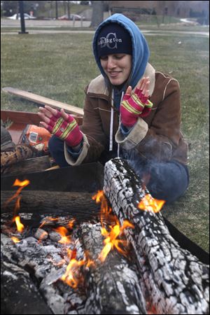 Hannah Jacobs, a social work major at Owens Community College, tries to keep warm. 