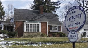 A realty sign lists an Old Orchard home for sale at 2810 Densmore in Toledo, Ohio.