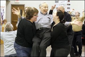 Ann Weiss, left, and Assistant director Kate Hoover, right, pick up Jim Bucher while they rehearse at the Zion Lutheran Church in Waterville for the Waterville Playshop production of '70, Girls, 70.' 