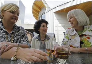 Bourbon Women members, from left, Jamie Estes, Peggy Noe Stevens, and Cynthia Norp enjoy a conversation over drinks of Kentucky bourbon in Louisville.
