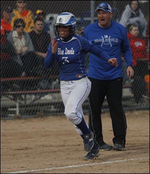 Springfield's Emily Rockman trots past coach Rob Gwozdz after slugging a two-run homer to give the Blue Devils a 2-1 lead in the fifth.