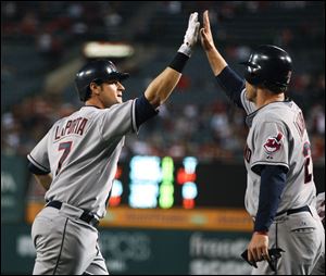 Cleveland Indians' Matt LaPorta, left, celebrates his three-run home run with Austin Kearns against the Los Angeles Angels during the second inning Monday.