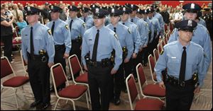 Members of the new police class waited six years from the time they took the initial academy entrance exam until Tuesday night's ceremony.