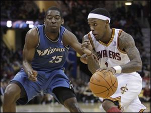 Cleveland's Daniel Gibson, right, drives on Washington's Jordan Crawford (15) in the first quarter.