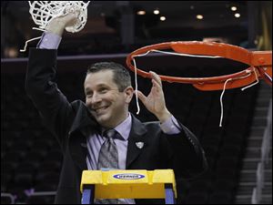 BGSU head coach Curt Miller waves the net after his team defeated Eastern Michigan during the 2011 Mid-American Conference Women's Basketball Final at Quicken Loans Arena in Cleveland, Ohio. 