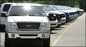 A line-up of 2006 Ford F-150 pickup trucks are shown on a dealership lot in Sterling Heights, Mich., in this August, 2006, file photo.