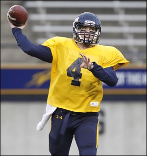 Gold team quarterback Austin Dantin throws the ball Friday during Toledo's spring football game.
