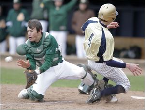 Clay catcher Josh Utter waits for the throw as St. John's player JJ Miller scores from second.