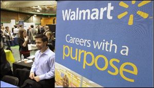 Representatives from Walmart speak to job seekers at a job fair held at Cleveland State University.