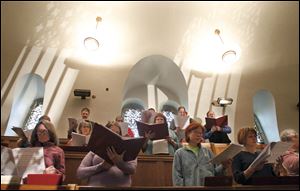 The Cathedral Choir rehearses for Holy Week services in the choir loft at Rosary Cathedral earlier this week. The choir will be key in a dramatic Wednesday service.
