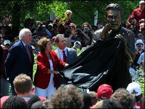 Terry Saban, the wife of Alabama coach Nick Saban, pulls the cover form the newly completed statue honoring the 2009 National Championship season as Alabama athletics director Mal Moore looks on during the Nick Saban statue unveiling at the University of Alabama on Saturday.