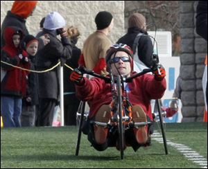 Richard Biggins of Toledo crosses the line first among the wheel-chair competitors in the Glass City Marathon.