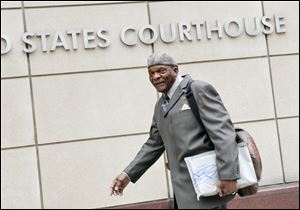 Retired Minnesota Vikings Hall of Fame player Carl Eller arrives Tuesday at the federal courthouse in Minneapolis where the NFL and its locked-out players continue court-ordered mediation.