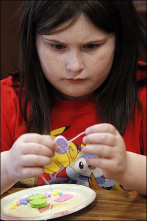 Chloe Ahern, 7, makes an Easter necklace. 