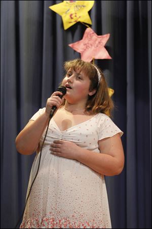 Faith Morgan sings during a talent show at Waterloo Elementary.
