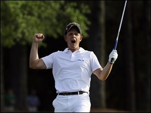 Luke Donald of England reacts after chipping in for a birdie on the 18th hole during the final round of the Masters golf tournament April 10, 2011, in Augusta, Ga.