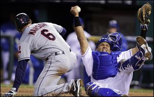 Cleveland Indians' Lou Marson (6) collides with Kansas City Royals catcher Brayan Pena as Marson tries to score on a Michael Brantley single during the seventh inning.