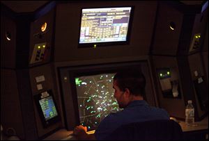 An air traffic controller works in a terminal radar approach control room Monday at the Atlanta TRACON in Peachtree City, Ga. 