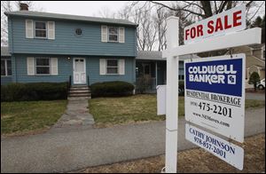 A home is posted for sale in North Andover, Mass. Sales of existing-home sales rose in March, continuing an uneven recovery that began after sales bottomed last Jul.