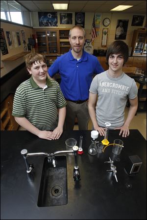 Ben Slaughterbeck, left, and Zach Vickers, right, students of Geoff Milewski, center, in their Northwood High School chemistry lab, made a science-based video.