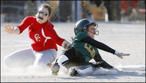 Clay's Danielle Holmes (2) is tagged out at second base by Central Catholic pitcher Erin Seiler (8).