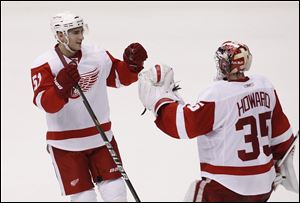 Detroit's Jimmy Howard, right, and Valtteri Filppula celebrate after a 4-2 victory over the Coyotes in their first-round playoff series.