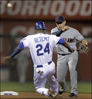 Cleveland Indians shortstop Asdrubal Cabrera, right, throws to first for the double play hit into by Kansas City Royals' Kila Ka'aihue after forcing Wilson Betemit (24) out at second during the seventh inning.
