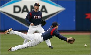 Toledo Mud Hens shortstop Cale Iorg dives but can't get a wind blown ball hit by Indianapolis' Josh Harrison during the fifth inning Wednesday morning of the Mud Hens' 4-2 loss at Fifth Third Field. The loss drops the Hens to 4-9 on the season.