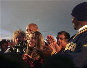 Lisa Zilba, a Scott High teacher who spoke at a rally last month with humorist Bill Cosby, center, will be his guest in Columbus Thursday night.