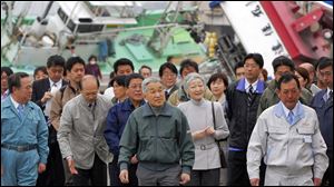 Japan's Emperor Akihito, center left, and Empress Michiko, center right, on Friday tour Otsu fishing port in Kitaibaraki, Ibaraki prefecture, northeastern Japan, which was heavily damaged by the March 11 earthquake and tsunami.