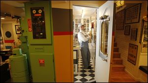 Steve Rathke, who works as a train engineer, is pictured in the kitchen area of a special room in his home that, like a museum, is filled with train items and memorabilia.