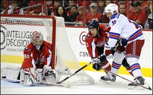 Capitals goalie Michal Neuvirth (30) stops the puck against Rangers left wing Sean Avery (16) during the second period.