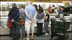A display of electronics at Unclaimed Baggage Center in Alabama attracts a crowd of browsers.