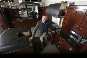 Steve Feldman shows off some of the high-end salvaged kitchen cabinets and appliances he sells at his showroom in Riverdale, N.J.