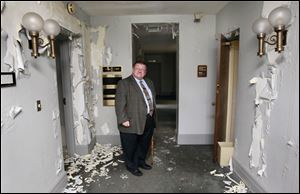 

Peter Ujvagi, Lucas County administrator, shows the the building constructed in about 1898 as the county sheriff’s residence and jail. Paint is peeling and plaster is falling.