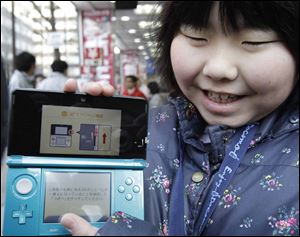 Nintendo said it expects conditions to recover with help from sales of the new Nintendo 3DS, shown here.