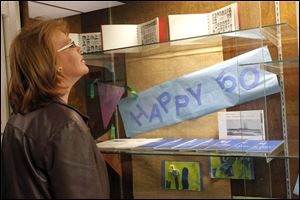 Brenda Pennington looks at a display case filled with yearbooks and memorabilia marking the golden anniversary. 