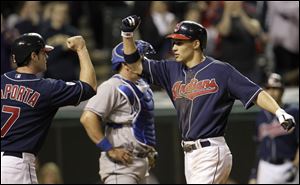 Cleveland Indians center fielder Grady Sizemore, right, is congratulated at the plate by teammate Matt LaPorta, left, after he drive him home with a two-run home run off Kansas City Royals relief pitcher Tim Collins in the eighth inning.