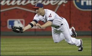 Cleveland Indians center fielder Grady Sizemore dives to catch a fly ball by Kansas City Royals' Melky Cabrera in the fifth inning Wednesday.