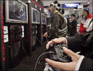 Visitors at the Sony Building in downtown Tokyo play Sony's PlayStation 3 in this file photo.